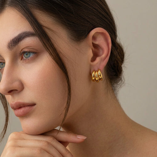 Chunky Gold Huggie Hoop Earrings worn on ear