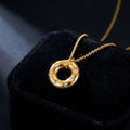 Gold Crystal Donut Pendant Necklace on black velvet