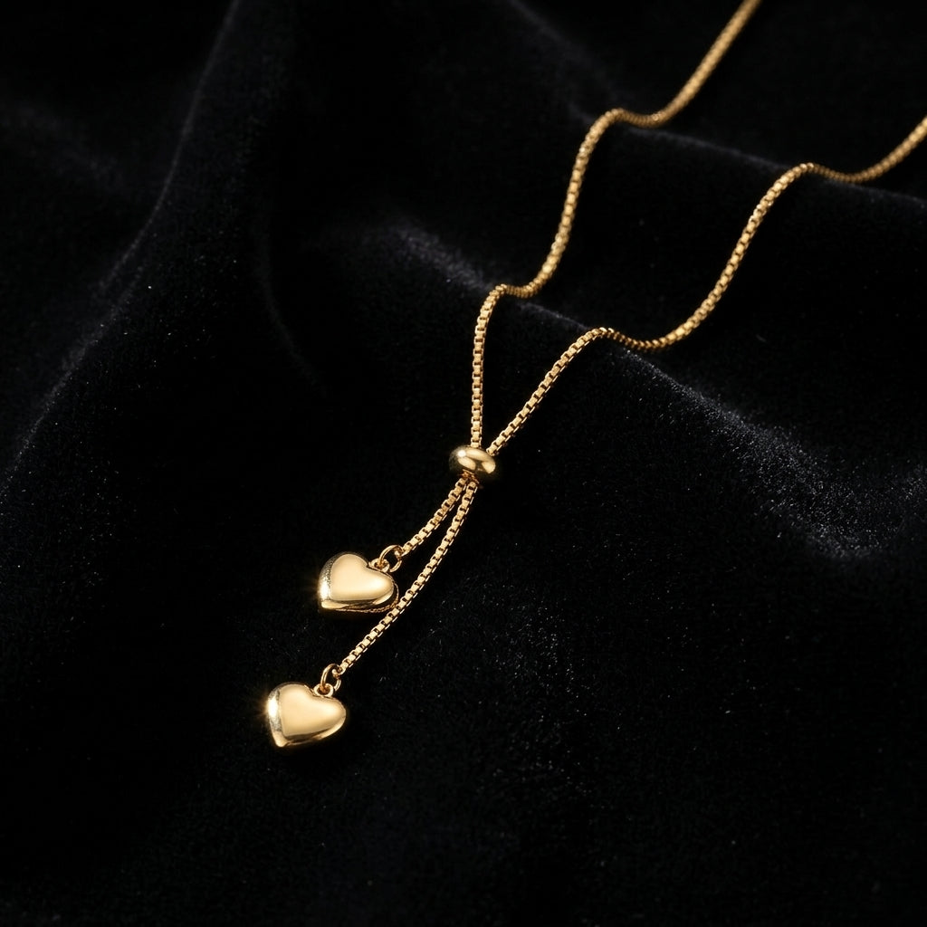 Dainty Gold Heart Lariat Necklace - Product on black velvet background