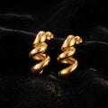 Twisted Croissant Hoop Earrings - Product on black velvet background