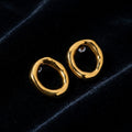 Sculpted Gold Oval Hoop Earrings on black velvet