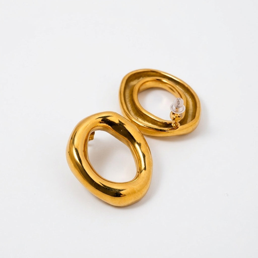 Sculpted Gold Oval Hoop Earrings on white background